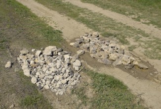 Road patching. Pits on the road are covered with stones. Atyrau, Kazakhstan