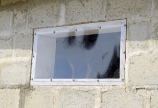 A window made of plexiglas in a concrete wall. Atyrau, Kazakhstan