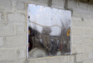 A window made of plexiglas in a concrete wall. Atyrau, Kazakhstan