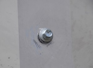 Screw screwed into plexiglas. Atyrau, Kazakhstan