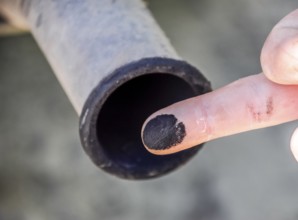 Soot from the exhaust pipe on the finger. Atyrau, Kazakhstan