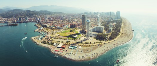 Aerial panoramic view Batumi cityscape with beach and promenade attractions, tourist in sunny