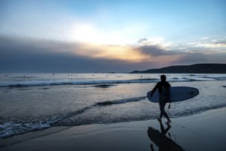 Male Surfer At Newgale Beach At The Atlantic Coast Of Pembrokeshire In Wales, United Kingdom