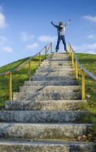 Young Boy On Top Of Outdoor Stairs On Hill Celebrates Success, Vienna, Austria