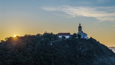 The sunrise illuminates the pilgrimage church of the Assumption of the Virgin Mary on the Bogenberg