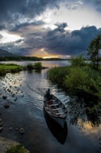 Boat returning from Lough Leane in Killarney National Park During Sunset in Ireland