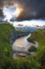 Canyon And Entrance With Bridge To Smoo Cave And Atlantic Coast At Sunset Near Durness In Scotland,