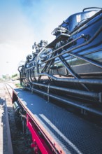 Detailed view of a black steam locomotive with focus on its mechanical parts and texture, Gera,