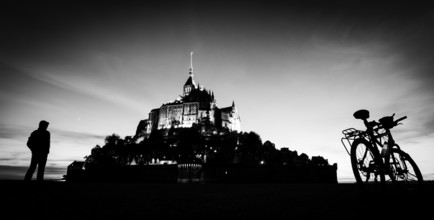 Saint Michel mount in France silhouette with person and bicycle