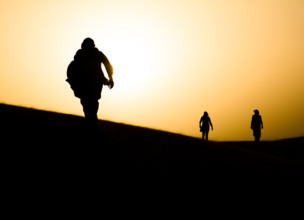 Nomads walking in Sahara desert. Egypt