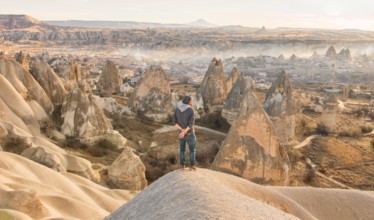 Male person with morning view of Goreme town in Cappadocia. Turkey travel