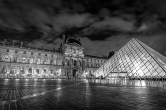 Louvre museum exterior at night in Paris