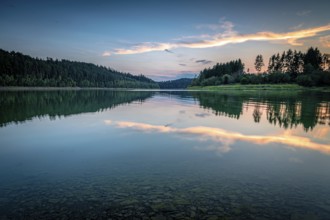 Reflection of clouds and trees in the water at sunset in a calm atmosphere, Zeulenrodaer Meer