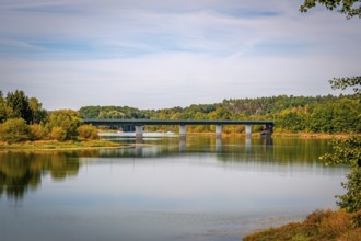 View of a bridge surrounded by green trees and a clear sky, Zeulenrodaer Meer reservoir,