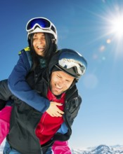 Happy young caucasian adult skiers couple in love having fun together playing enjoy leisure