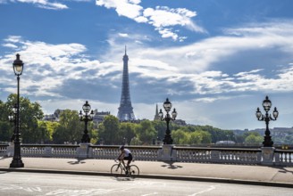 Bridge Pont Alexandre III Over River Seine With Single Bicycle Rider And View To Eiffel Tower In