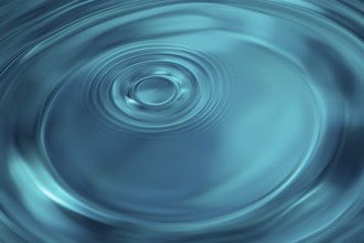 Water Drop Creates Circular Waves on Calm Surface Of Blue Water