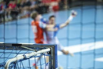 Detail of the handball goal and blurred players in action in the background. Lubin, Poland