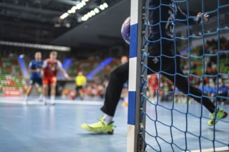 Detail of handball goal post when the ball hits it. Handball match in the background. handball.