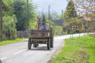 Tractor driving through the stork village, Cigoc, Sisak-Moslavina County, Croatia