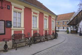 Alley in the old town centre with wrought-iron benches made from old metal parts, Varaždin,