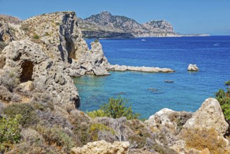 Clear blue coastal landscape Grande Blue with rocky coastline and calm sea under a clear sky,