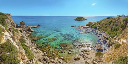 Grande Blue Bay with clear, turquoise-coloured water and rocks in sunny weather, Grande Blue Beach,
