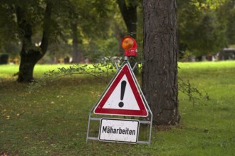 Sign, warning sign, mowing work, main cemetery, Stuttgart, Baden-Württemberg, Germany