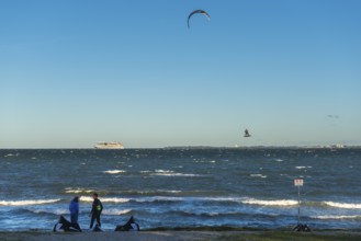 Kitesurfing in the Bay of Kiel in strong winds, high swell, Big Air Jump, Strande near Kiel,