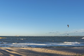 Kitesurfing in the Bay of Kiel in strong winds, high swell, Big Air Jump, Strande near Kiel,