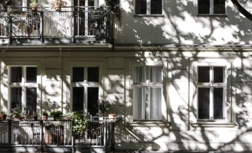 Facade of a multi-storey residential building with classical architecture with balconies with