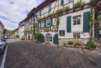 Old town, alley, historic half-timbered houses, facade with windows and shutters, cellar hatches,