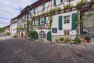 Old town, alley, historic half-timbered houses, facade with windows and shutters, cellar hatches,