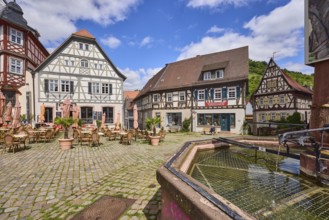 Old town, stone fountain, water, historic half-timbered houses, cobblestone square, outdoor area of