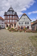 Old town, historic half-timbered houses, cobblestone square, outdoor area of a restaurant, visitors