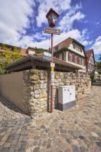 Old town, lantern, signpost to the museum, quarry stone wall, historic half-timbered houses,