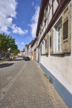 Half-timbered houses, general architecture, street, car park with vehicles, facade with windows and