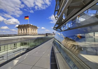 Viewing platform with a German flag in the wind on one of the corner towers and reflection in the