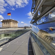 Viewing platform with a German flag in the wind on one of the corner towers and reflection in the