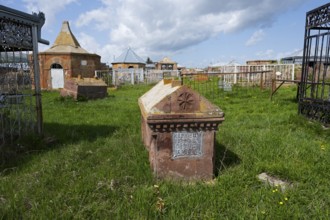 An old cemetery with decorated gravestones and inscriptions on a green meadow, Gravestone,