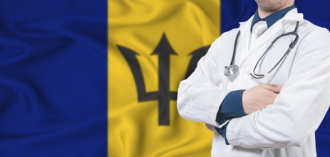 Barbados healthcare concept. Male doctor on Barbados flag. Doctor with crossed arms on Barbados
