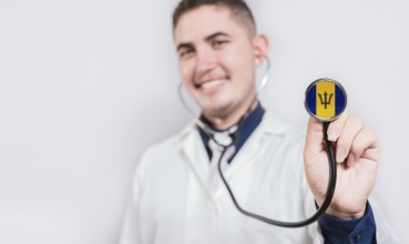 Doctor showing stethoscope with Barbados flag. Barbados national healthcare concept