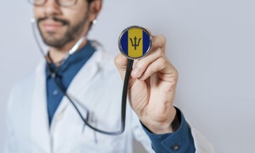 Doctor holding stethoscope with Barbados flag. Barbados health and care concept, Barbados flag on