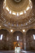 An interior with a domed golden dome and impressive pillars of light that create a majestic