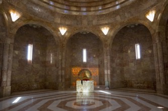 An impressive hall with a vaulted ceiling and marble floor in golden tones, light floods in through