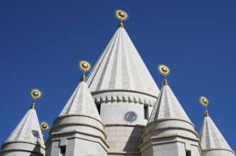 White architectural church tower with geometric shapes against a blue sky, Yazidi temple, Yazidi