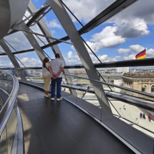 Interior view of the Reichstag dome with visitors and the German flag, Reichstag building,