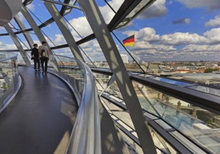 Interior view of the Reichstag dome with visitors and the German flag, Reichstag building,