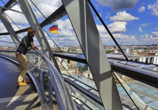 Interior view of the Reichstag dome with visitors and the German flag, Reichstag building,