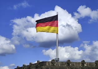 View from the Reichstag dome of a German flag in the wind in front of a cloud, Reichstag building,